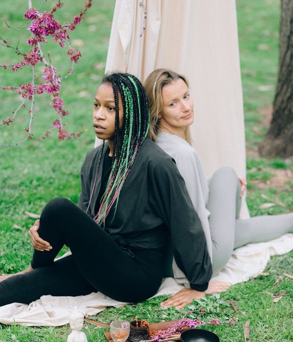 Woman performing a gentle stretching exercise in a calm setting.